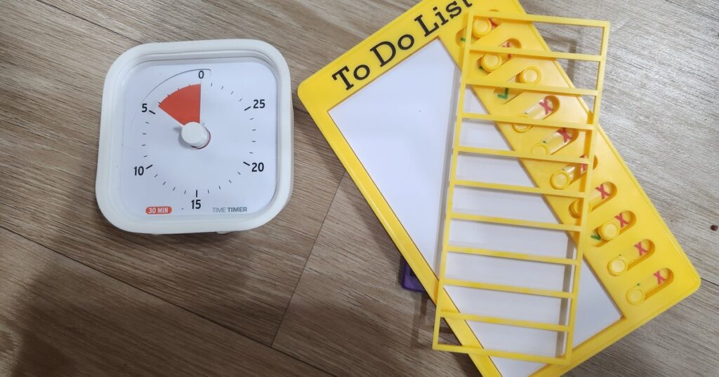 A clock beside a to-do list — ADHD time blindness makes deadlines feel far away until they're suddenly now